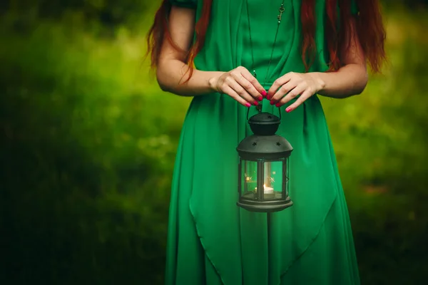 Woman holding lantern with candle — Free Stock Photo