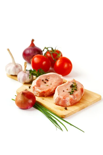 Fresh pork meat steaks with vegetables — Stock Photo, Image