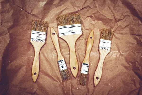 Set of five renovation brushes on craft paper — Stock Photo, Image