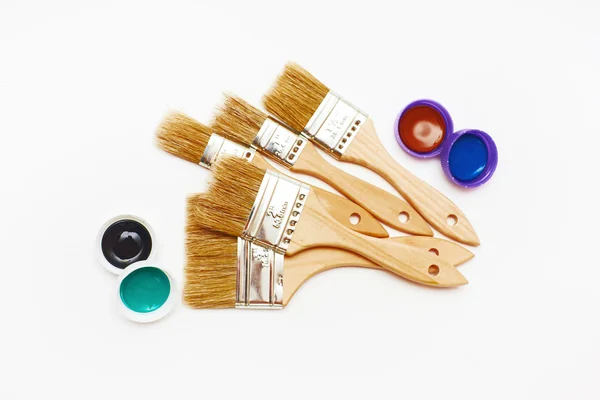 Set of five new renovation brushes with paint — Stock Photo, Image