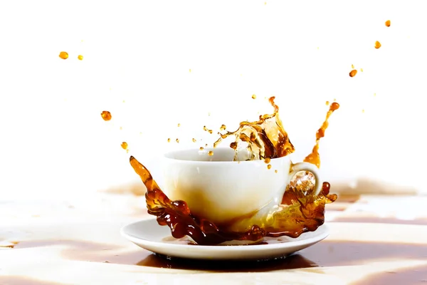 Cup of coffee creating splash — Stock Photo, Image