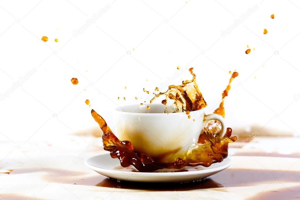 Cup of coffee creating splash