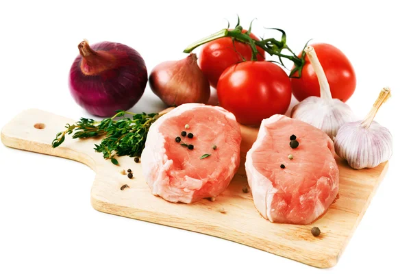 Fresh pork meat steaks with vegetables — Stock Photo, Image