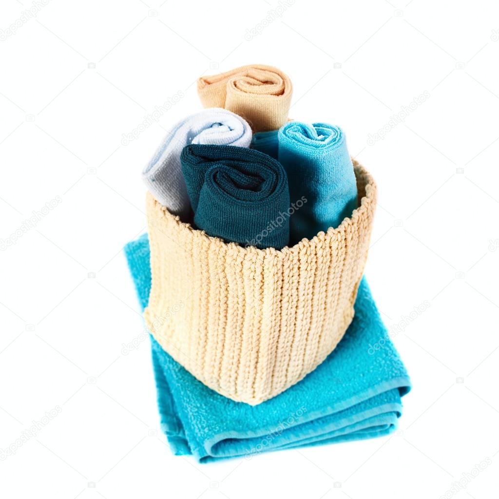 Colorful towels in a basket isolated 