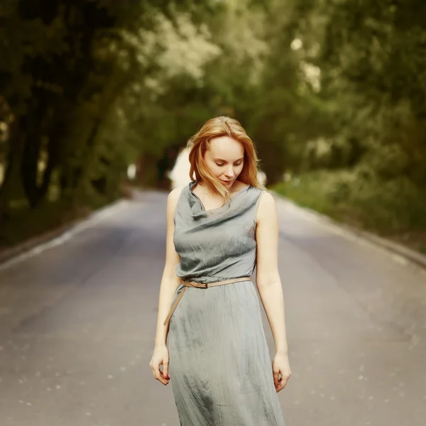 Young blonde attractive woman standing on the road — Stock Photo, Image