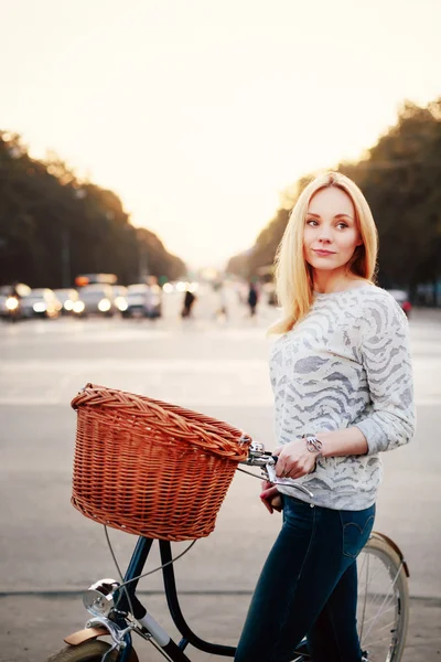 Calm woman on a vintage bicycle in the city