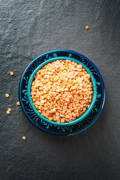 Red Lentil Halves in a Wooden Spoon