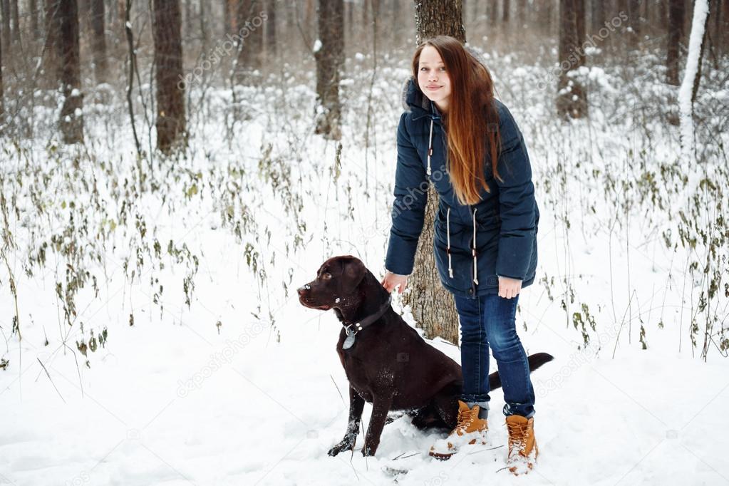 Female Walking with Labrador Dog in Forest