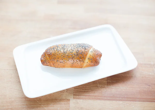 Beautiful delicious poppy seed roll on a plate — Stock Photo, Image