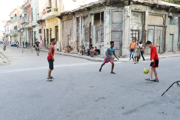 Childs playing football on the street — Stock Photo, Image