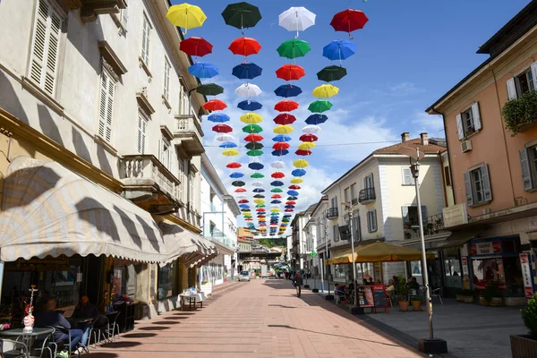 Many colorful umbrellas hanging on the pedestrian street of Chia — Stock Photo, Image