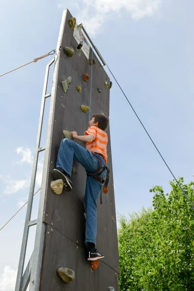 Effort d'un garçon en escaladant un mur — Photo