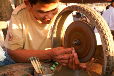 People processing of semi-precious stones on a factory of Mandal clipart