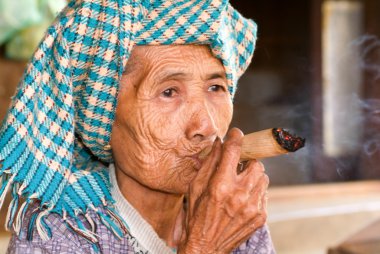 Old woman smoking a big cigar clipart