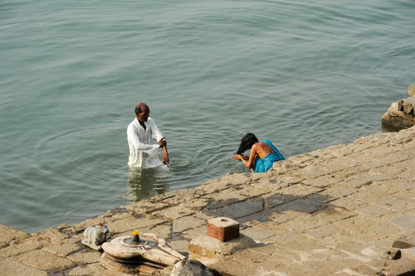 Orang-orang mencuci pakaian di ghats sungai suci Narmada di Maheshwa — Stok Foto