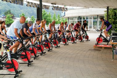 İnsanlar bir spinning dersi sırasında pedal