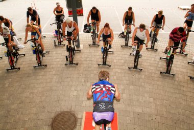 İnsanlar bir spinning dersi sırasında pedal