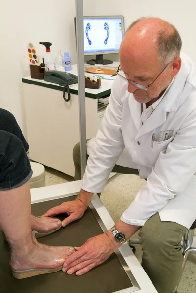 Arts orthopedische inlegzolen voorbereiden op een patiënt op zijn studio — Stockfoto