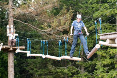 Visitors in adventure park clambering