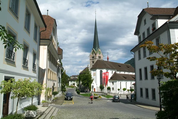 People walking in front of the church at Stans — Stock Photo, Image