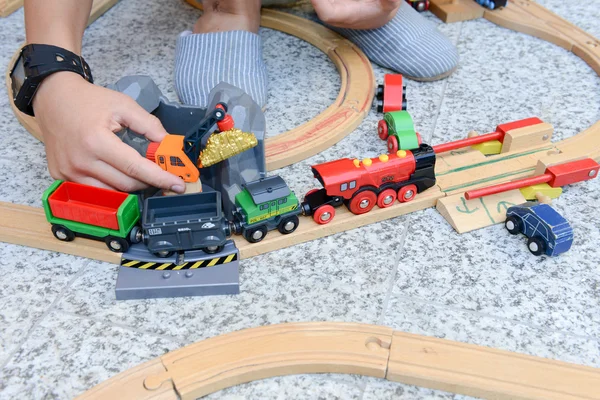 Мальчик играет с деревянным поездом — стоковое фото