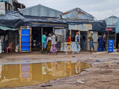 Afdera, Etiyopya - 20 Ağustos 2025: Etiyopya 'da Afdera' nın çamurlu sokaklarında yürüyen insanlar