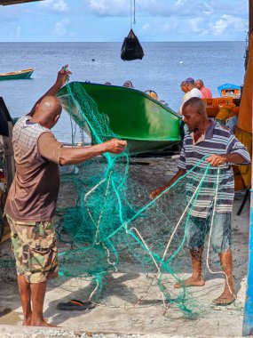 Scotts Head, Dominica - 12 Ocak 2026: Dominica 'daki Scotts Head' de balık ağını çeken iki balıkçı