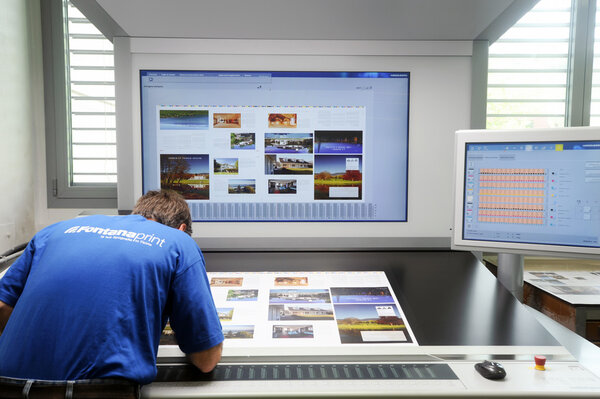 Printer checking a print run at table