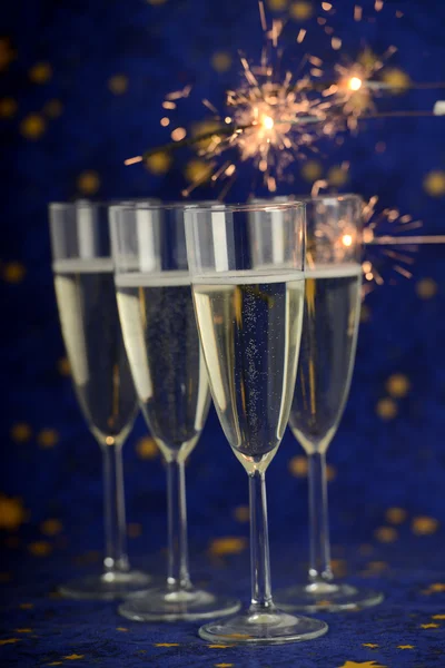 Glasses with champagne against holiday lights — Stock Photo, Image