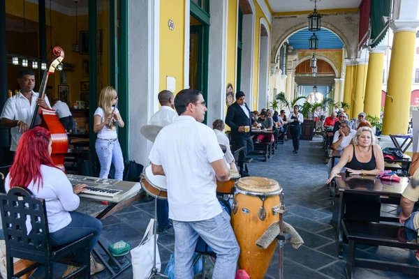 People drinking and listening to live music at a restaurant — Stok fotoğraf