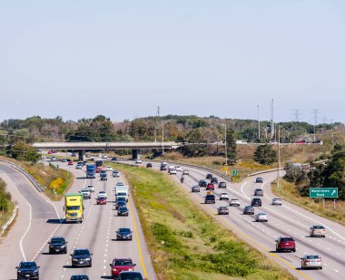 BURLINGTON, ONTARIO, CANADA - SEPTEMBER 23, 2018: Traffic on Highway 403 near the interchange with Waterdown Road. clipart