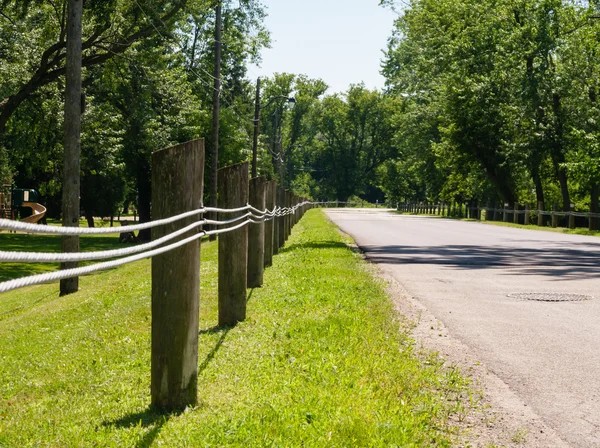Short fence posts with steel lines — Stock Photo, Image