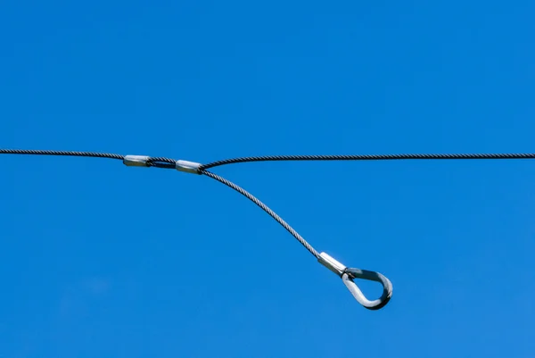 Single thin metal cable loop hanging on sky — Stock Photo, Image