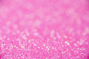 Pembe parıltı dokusu. Yeni yıl ya da tebrik kartı için yeni yıl arkaplanı. Sevgililer Günü kutlaması. Şenlik dekorasyonu için parlak bir tasarım: düğün, bayram veya yıldönümü partisi.