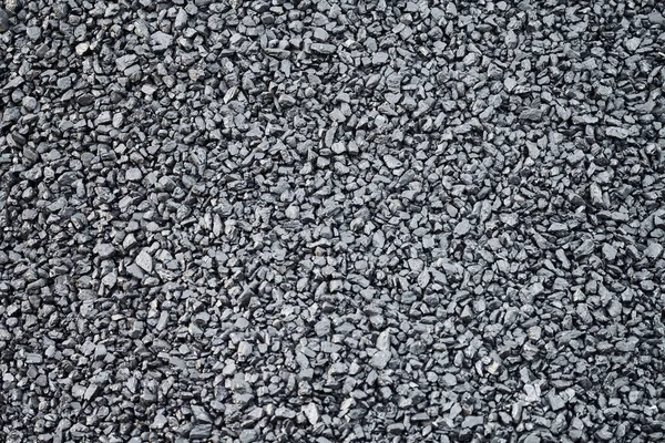 Natural black charcoal texture for background, fuel for coal industry. Top view, close up.