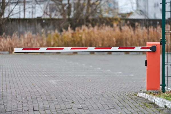 Parking gate, automatic car barrier system for car-park security. White red boom gate.