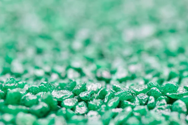 Emerald green gemstone pattern. Glitter semiprecious stones for decoration, flat lay, top view background. Shallow DOF