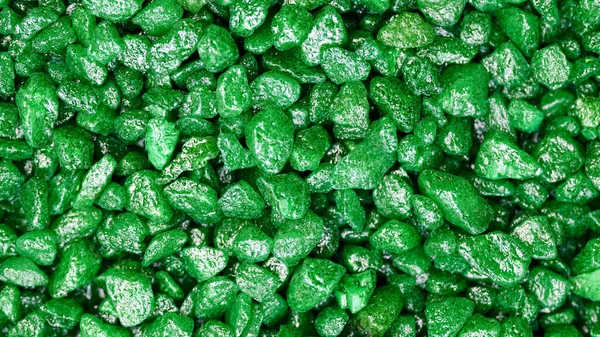 Emerald gemstone fake pattern. Green glitter stones for garden decoration, flat lay, top view background.