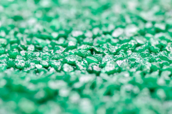 Emerald green gemstone pattern. Glitter semiprecious stones for decoration, flat lay, top view background. Shallow DOF