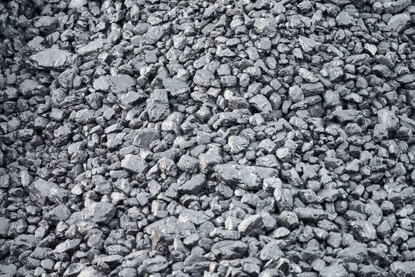 Natural black charcoal texture for background, fuel for coal industry. Top view, close up.