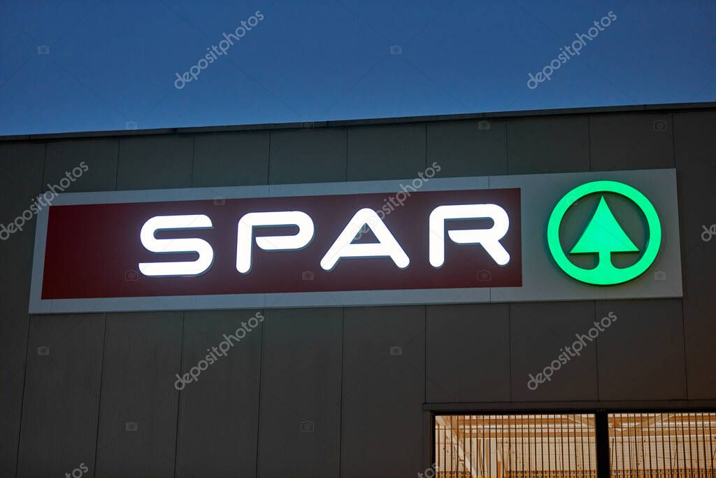 Kaliningrad, Russia - 02.05.2021 - Spar logo on one of supermarkets. Company neon signboard Spar in evening. International retail chain and franchise.