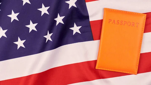 Passport on United States of America flag. National USA flag, patriotic symbol of America. Emigration concept.