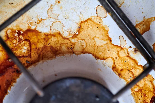 Dirty stove with food leftovers. Unclean gas kitchen cooktop with greasy spots, old fat stains, fry spots and oil splatters.