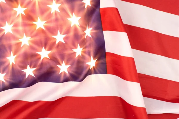 United States of America flag. Glowing stars on USA flag, patriotic symbol of America. Close up flag waving in wind.