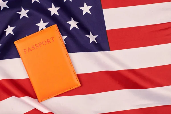 Passport on United States of America flag. National USA flag, patriotic symbol of America. Emigration concept.