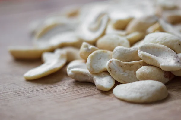 Cashew nuts on a wooden board — Stock Photo, Image