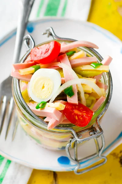 Sausage ,cheese and vegetables salad in a glass jar — Stock Photo, Image