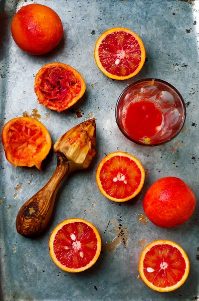 the fresh bloody oranges cut in half on a vintage metal tray.