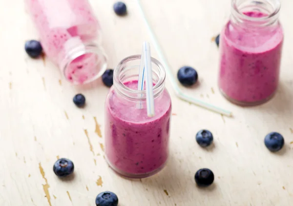 Bilberry smoothie in glass small bottles — Stock Photo, Image