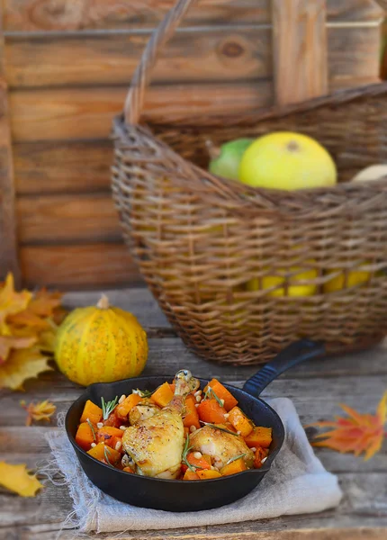 The baked chicken with pumpkin in a pig-iron frying pan — Stock Photo, Image